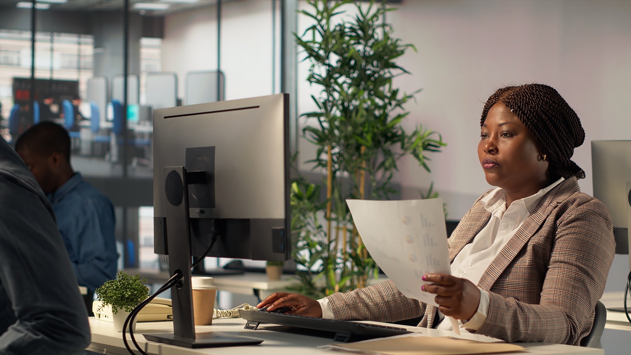 An iPRO Botswana portfolio manager reviewing financial planning data in the firm's Gaborone office